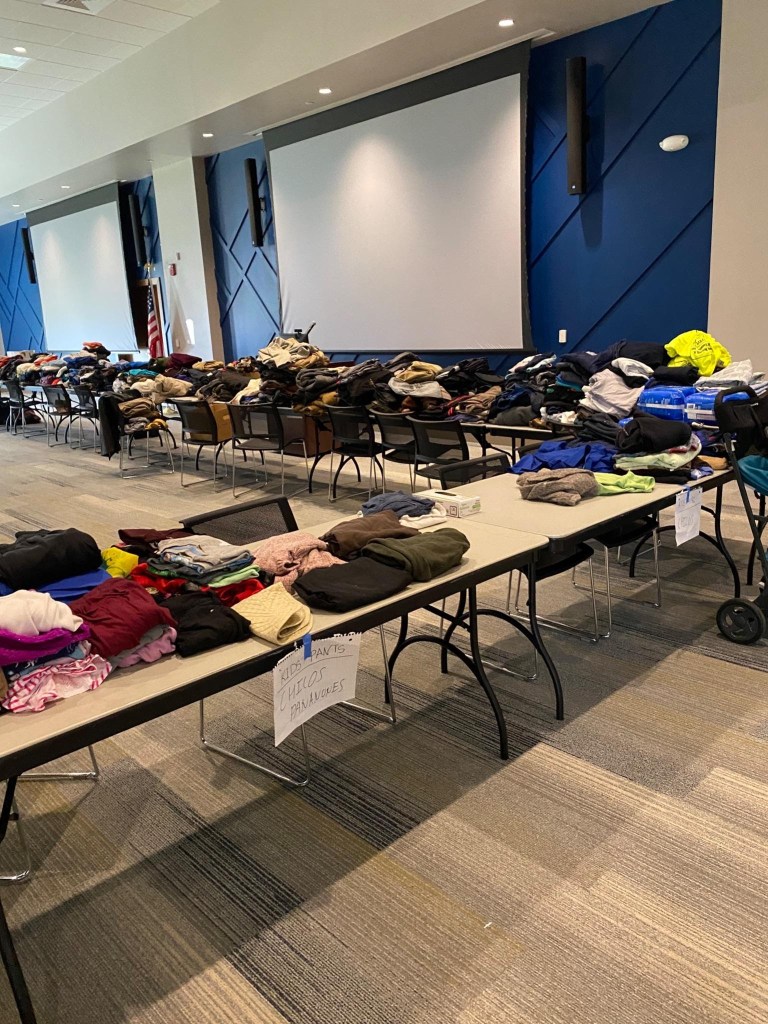 Tables covered with clothes donated at the Student Day of Service-Learning. Photo courtesy of Kirsten Collins. 